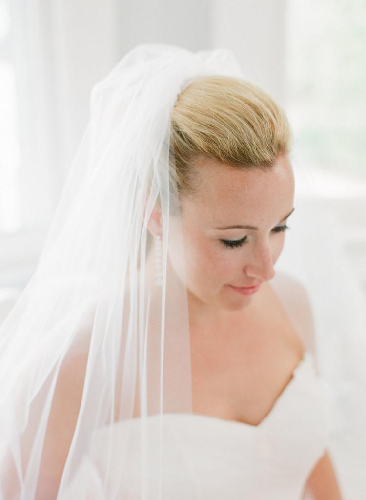 Hair and makeup by Ashley Brook Perryman. Bride&#039;s gown by Monique Lhuillier, available in Charleston through Maddison Row. Earrings by Ippolita, available in Charleston through REEDS Jewelers. Bridal styling by Lindsey Nowak and Cacky&#039;s Bride + Aid. Photograph by Corbin Gurkin.