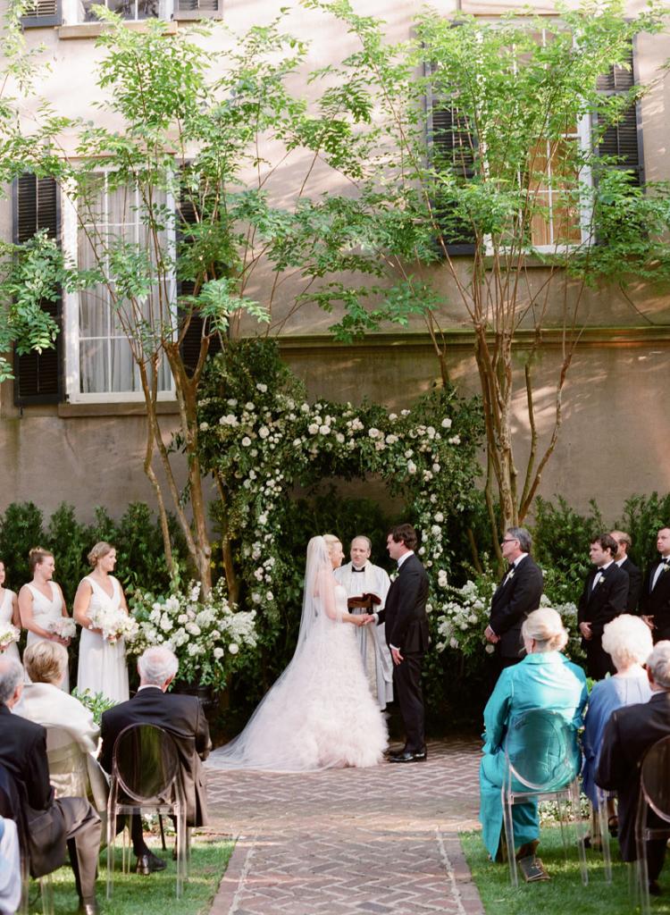 “I wanted to get married with guests sitting on the lawn and looking down from the first, second, and third floor piazzas,” says Cate. “The anticipation of having the wrought-iron gates open, walking down to Hugh and looking up and around at our friends and family was the most exciting moment I could possibly imagine. In reality, it was even  more special.”