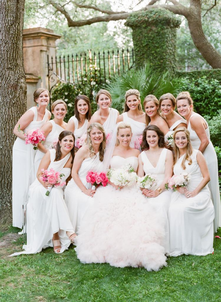 Cate’s blush-hued gown paired with her bridesmaids’ ivory dresses (the bride and her attendants all wore Monique Lhuillier) and their mix-and-match blooms made for a pink and white ombré effect.