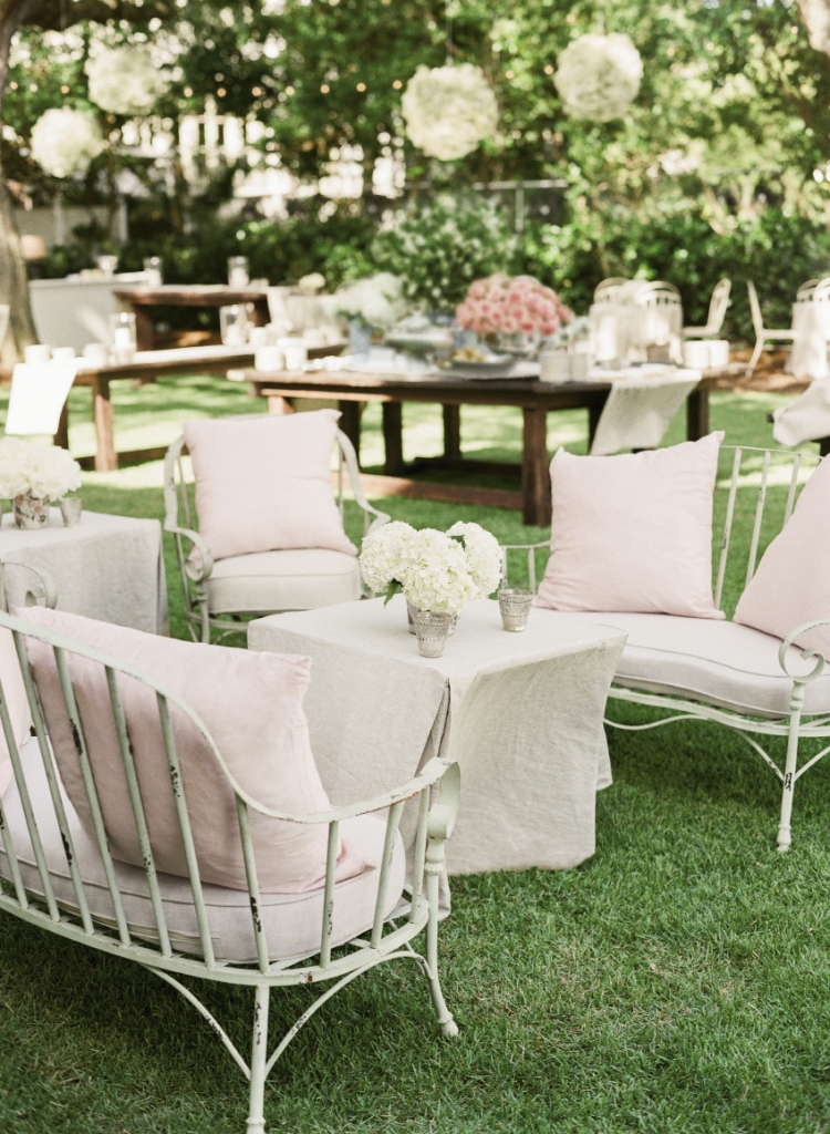 French-style wrought iron furniture with linen cushions  offered the perfect respite for party-hearty guests.  Wedding design and linens by Tara Guerard Soiree. Rentals by Snyder Events. Florals by Tara Guerard Soiree. Photograph by Corbin Gurkin.