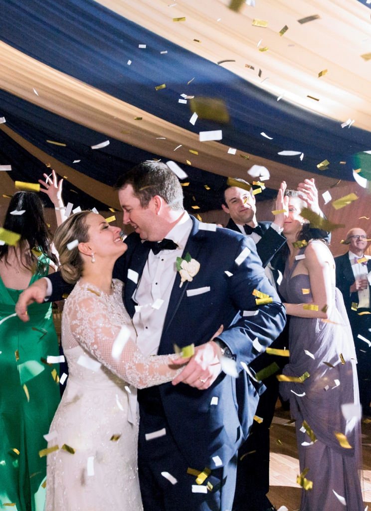 “Skip and I had a rule that we would take breaks every so often to hold hands and savor the details together,” Laura explains. Exhibit A: this stolen moment just as the confetti cannon exploded. (Photo by Corbin Gurkin)
