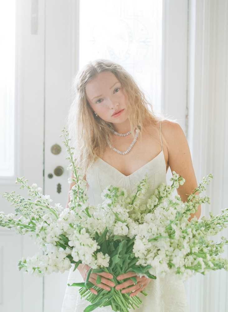 Lela Rose’s “The Desert” floral fil coupé gown from Maddison Row. Swarovski crystal and milkstone earrings from Gown Boutique of Charleston. Colibri Collections chalcedony necklace from RTW. Hybrid delphinium and stock flowers from Tiger Lily Weddings. &lt;i&gt;Photograph by Corbin Gurkin&lt;/i&gt;