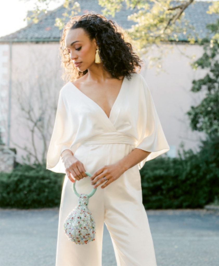 Theia’s “Simona” silk kimono-sleeved jumpsuit from Fabulous Frocks. Hart Hagerty’s topknot tassel earrings from Hart. Sapphire band and rutile ring, both from Croghan’s Jewel Box. David Jeffery’s beaded bag from Out of Hand.