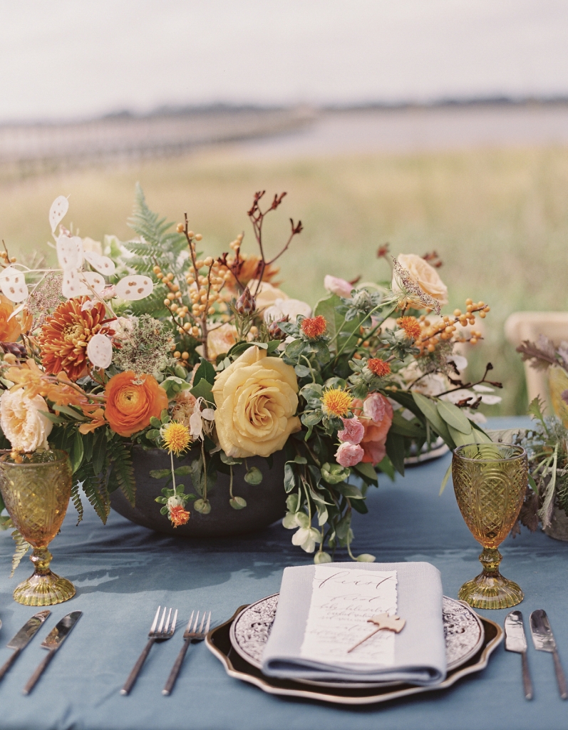 Elegant autumnal floral centerpieces by Vero Designs echoed the fall hues of the marsh grass along the Ashley River, an element of refinement that still lets the drama of the setting take center stage.