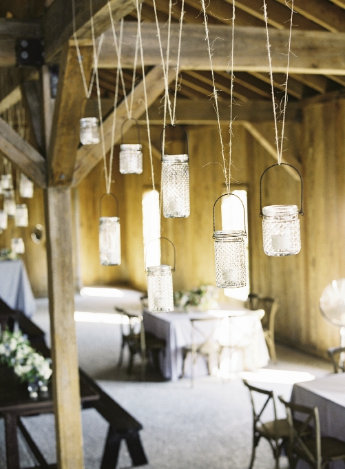 UP IN THE AIR: Event designers Kristin and Heather tucked candles into hobnail jars, then used twine to hang the vessels at varying heights from the Cotton Dock’s ceiling beams. “The décor was simple, but fit us perfectly,” says Marianna.