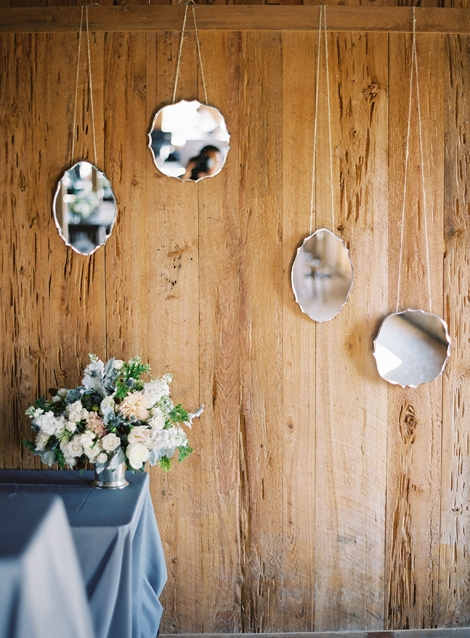 SCATTER SHOT: Hanging mirors in clusters helped to reflect light for a romantic—and functional—effect.