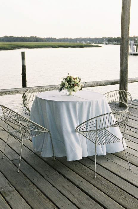 DOCK SITTIN’: Wire garden chairs provided seating for guests to take in views of Wampacheone Creek.