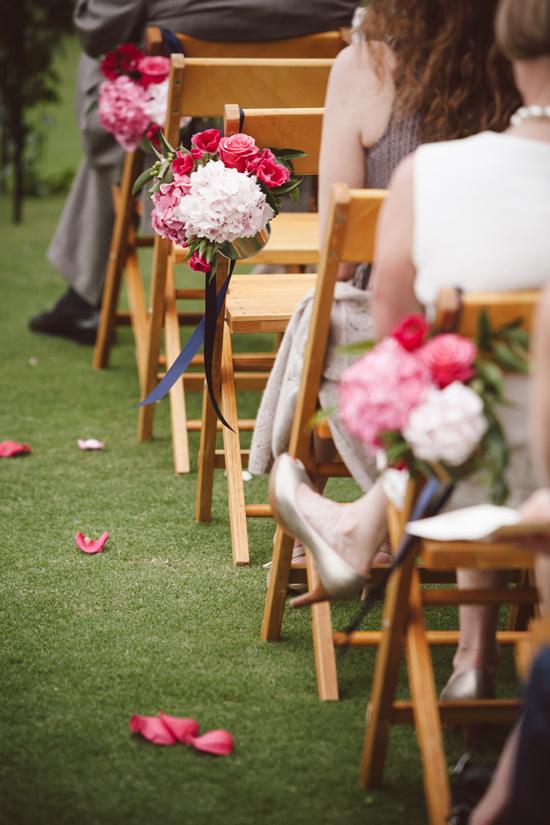 PALETTE PLAY: Gathering Floral Event + Design tied floral bundles to chairs with navy ribbon to create aisle markers.