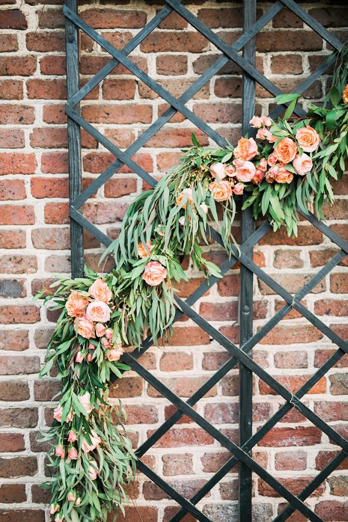 A snaking garland of peach roses and leafy greens woven into the trellis in the restaurant’s courtyard imparts a clever idea: Set up a floral installation like this for your ceremony backdrop, then let it serve as a selfie station during your the reception.