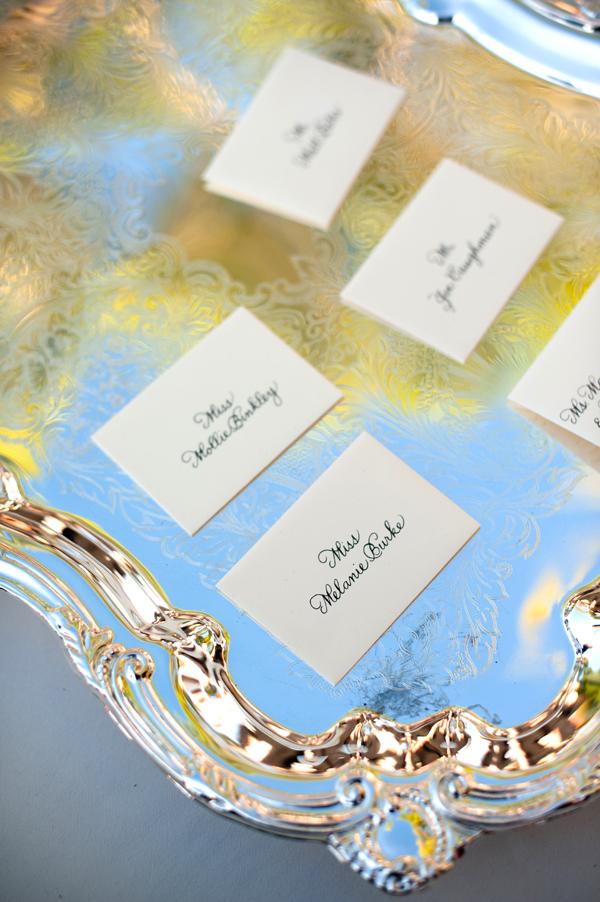 A FORMAL AFFAIR: Place cards rested atop antique silver trays.