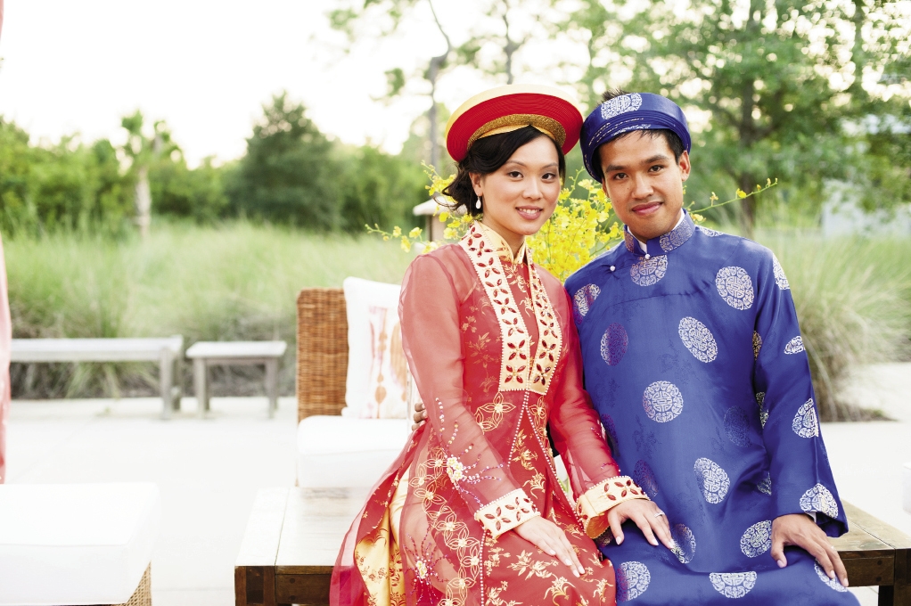PAST PRESENT: Linda and Vu changed from modern wedding wear into traditional Vietnamese áo dài garments in vivid silks.