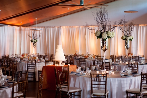 FLORAL NOTES: Tall, branch-filled arrangements accented with white hydrangeas filled the airy reception space.