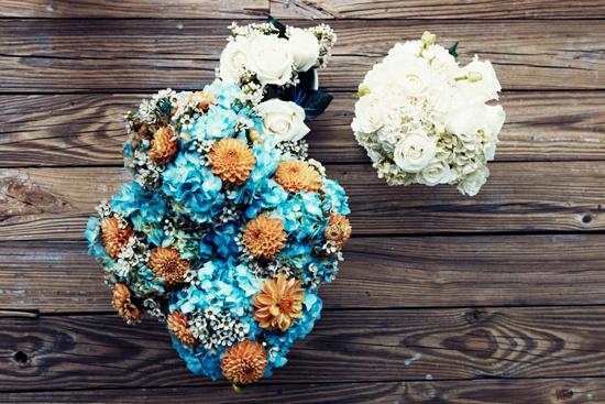 CAST OF COLORS: Lisa arranged an all-white bridal bouquet and bridesmaid bunches of blue hydrangea, cream-colored wax flowers, and orange dahlias.