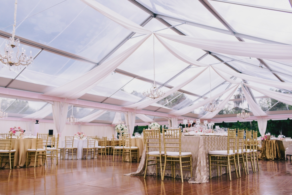 A clear-top tent with minimal draping provided shelter while preserving the alfresco feel of the reception. &lt;i&gt;Photograph by Hyer Images&lt;/i&gt;
