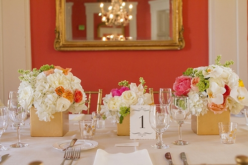 PALETTE PLAY: If your venue has bold walls—like the coral hue in the William Aiken House—keep the rest of the décor simple and tie it all together with the centerpieces.