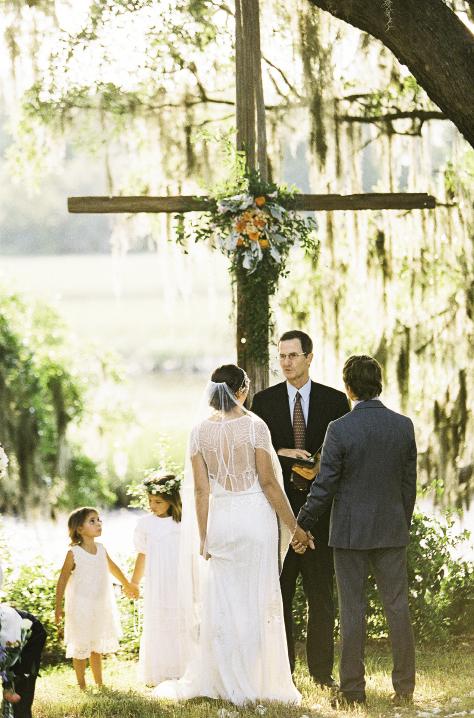 SWEET THING: The couple’s daughter watched intently as her parents wed on the banks of Horlbeck Creek.
