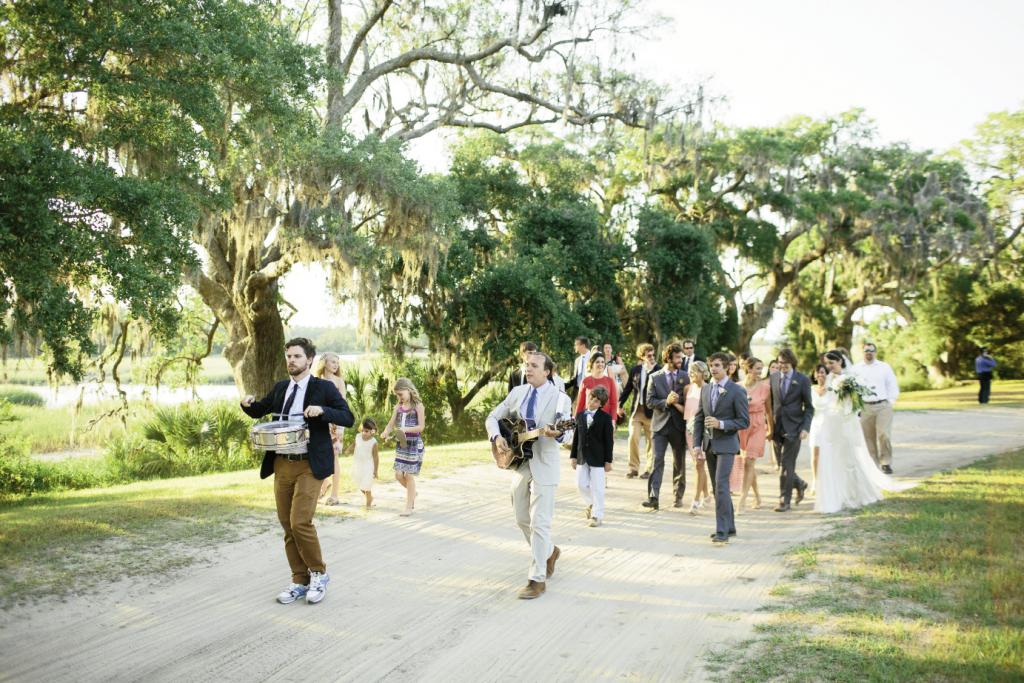 MARCH ON: Charles Carmody—director of Charleston Music Hall and a friend of the couple’s—and Bennett MacNath led a parade from the ceremony site to the reception.