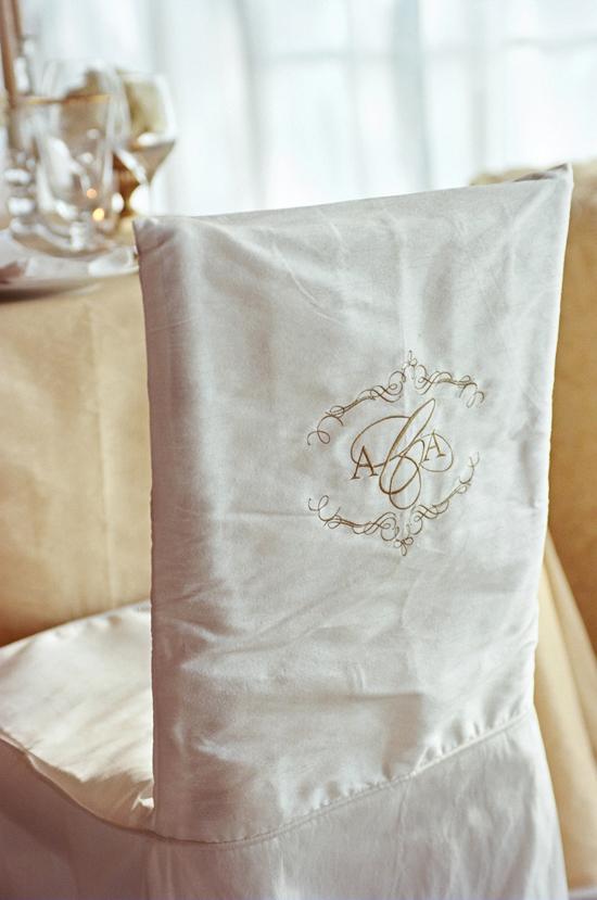 MAKE A MARK: The bride and groom’s dinner chairs were decorated with monogrammed seat covers.