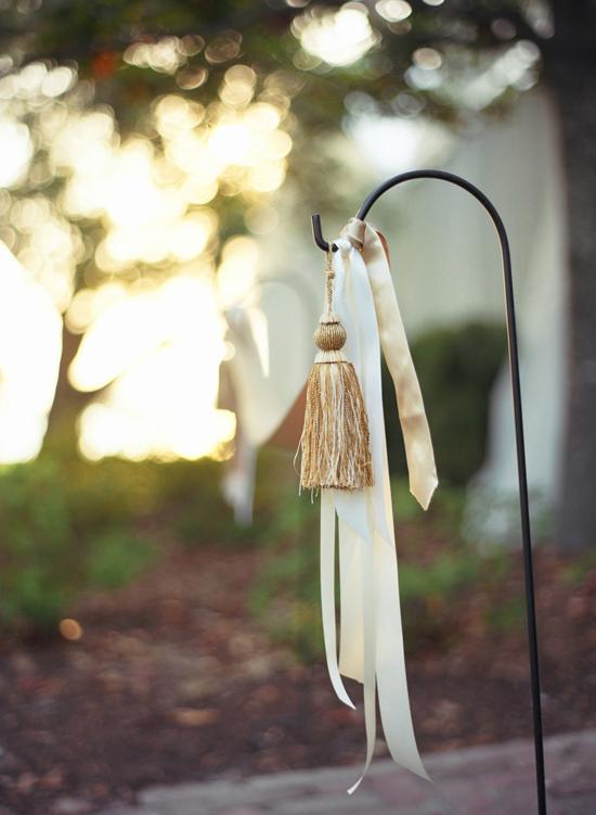 HANGING ADORNMENT: Soirée strung yard stakes with ribbons and tassels for a traditional touch that was more affordable than flowers.