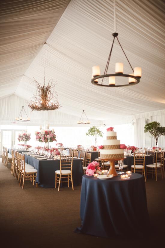 BRANCH OUT: To bring the woodland motif indoors beneath the tent, Gathering Floral + Event Design hung a statement chandelier made of branches.