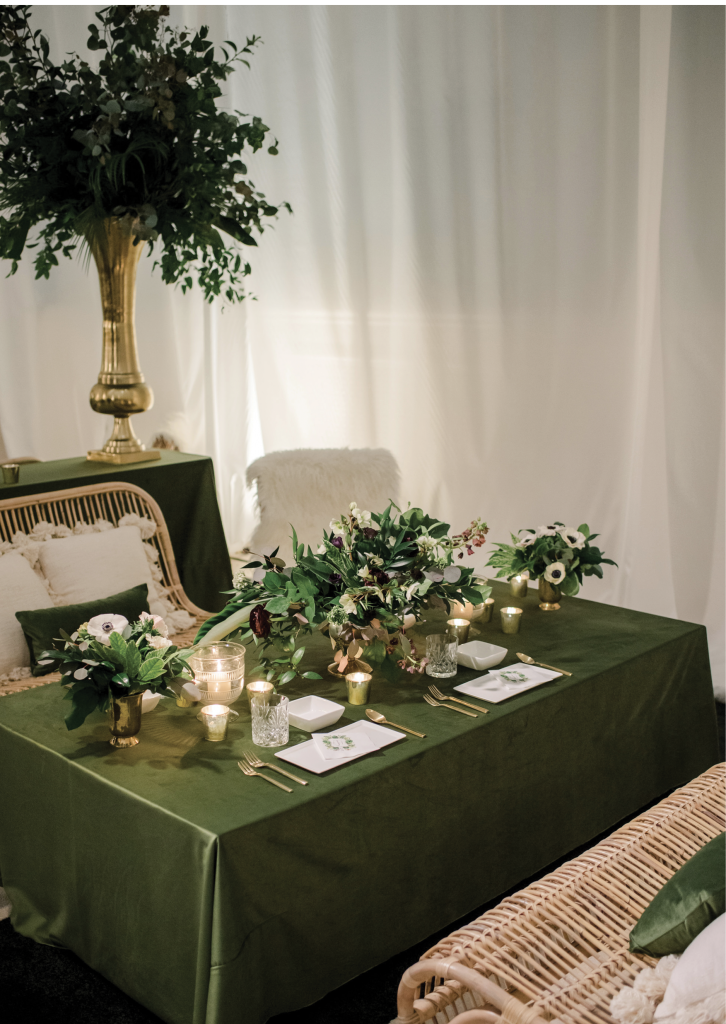 Dark green silk and velvet finishes, scattered tea lights, and textured throw pillows provided a moody ambiance in the cocktail lounge.