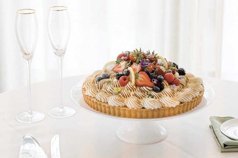In lieu of a tiered wedding cake, the couple cut into a lemon chess pie garnished with fruit and flowers from the Dewberry’s garden, which guests enjoyed alongside a chocolate praline cheesecake.