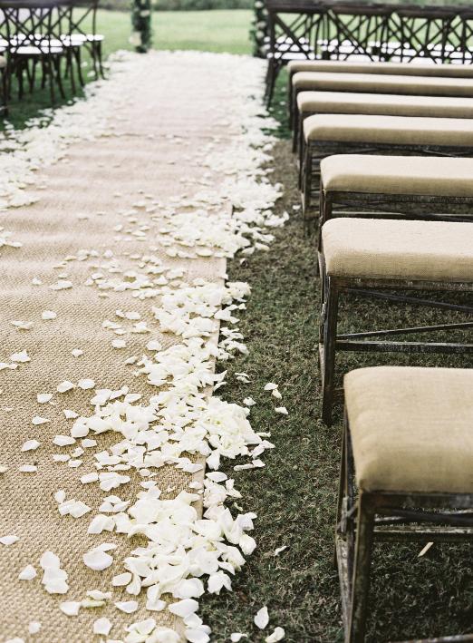 A shower of rose petals softens the border of any aisle runner, like this one of seagrass. Looking for something similar? GDC Home stocks samples that you can use for your ceremony... and in your new home.
