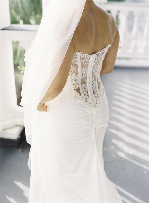 Alice’s Inbal Dror gown featured the hautest trend in bridal wear: a low-cut back of illusion lace and corset boning. For a demure touch during the ceremony, she donned a trailing veil.