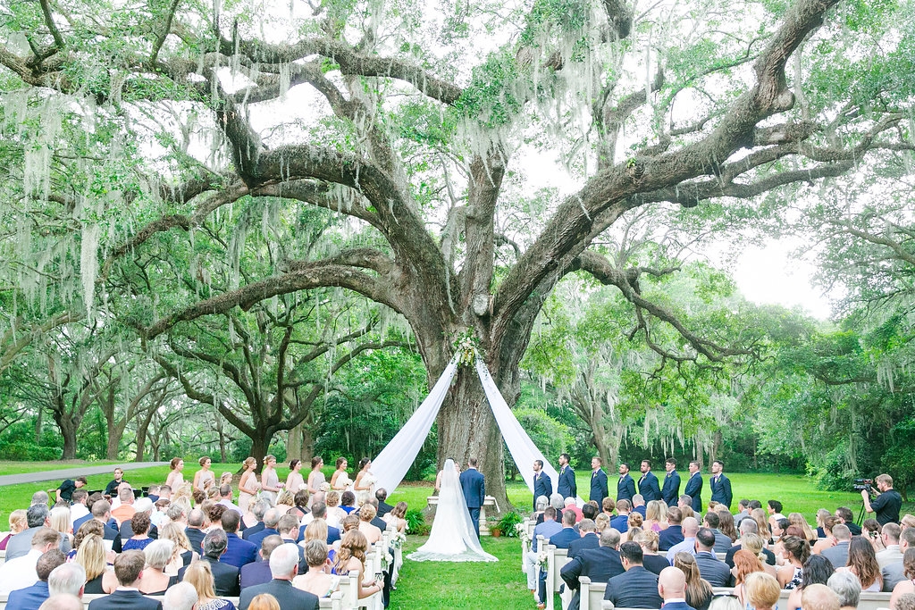 Andra liked the idea of marrying in a church but recognized the logistical benefits of hosting both ceremony and reception at one place, so Stacey fashioned an alfresco chapel of sorts using pews from Snyder Events.