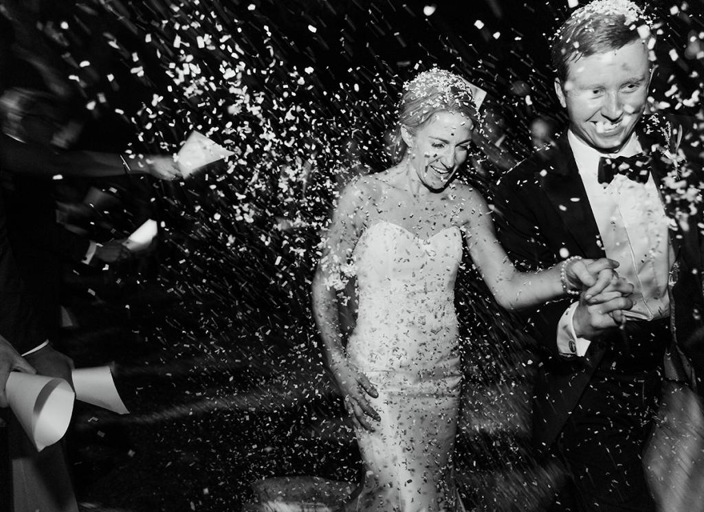 White, biodegradable “Ecofetti” rained down on the newlyweds before they headed off to their honeymoon in Costa Rica.