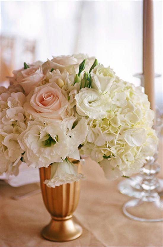 CLASSIC TOUCH: Ashley says she wanted the décor to paint a “traditional and timeless” picture of the day. “I chose to do all white flowers and champagne and gold accents,” she says.
