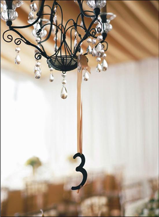 DANGLING DIGITS: Hanging table numbers were easy to spot and filled the air between the chandeliers and table settings.