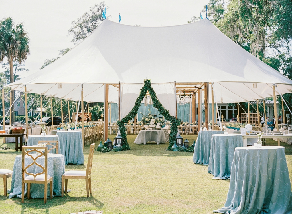 Mere steps from the chapel, the sailcloth tent on the Village Green beckoned guests to celebrate al fresco. A gospel choir serenaded the couple and their guests with “You Are My Sunshine” as they strolled into the party.