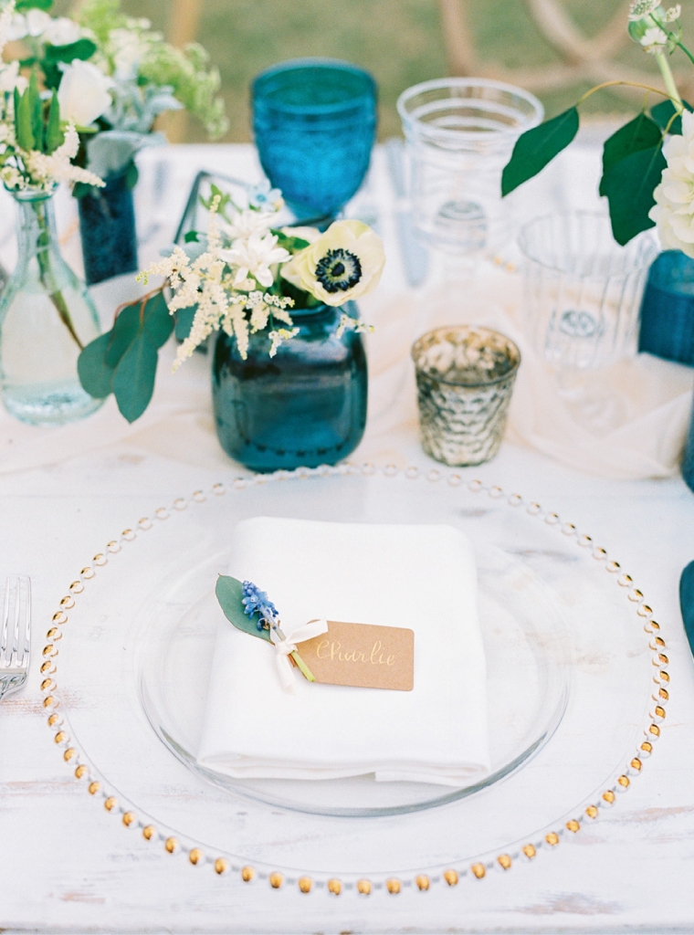 Gilded glass chargers add a dash of elegance to any place setting. Calligraphing an otherwise simple place card like this one transforms it into something sophisticated