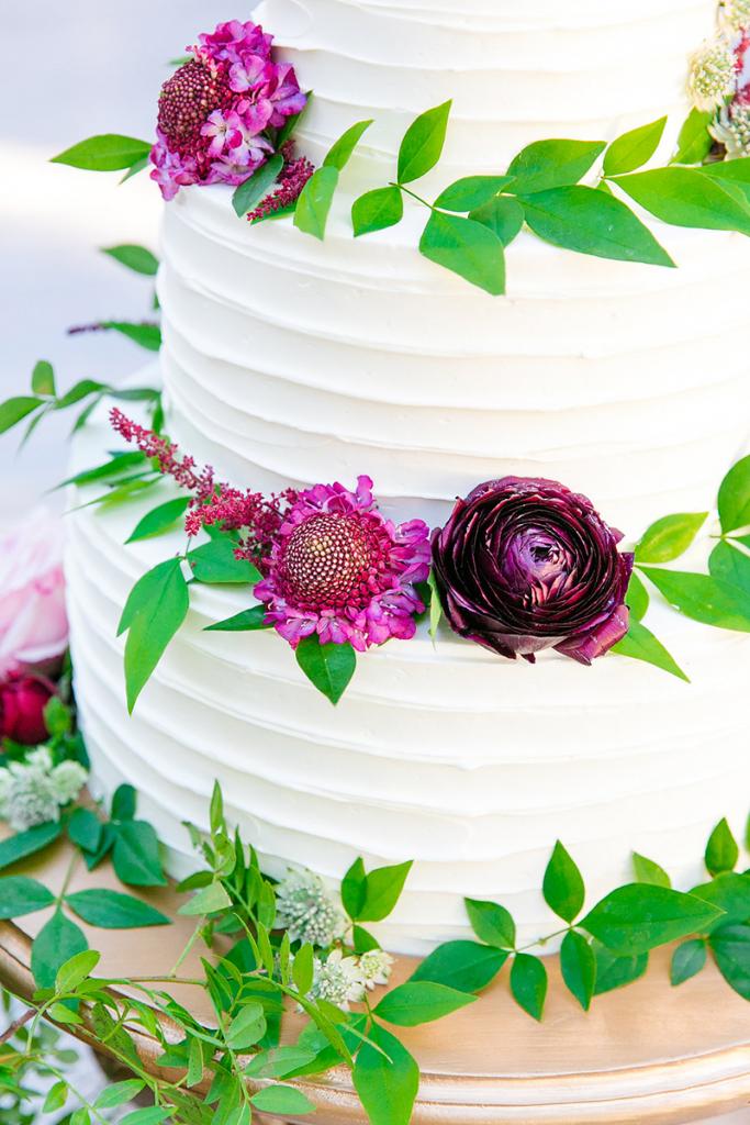 Showcase colorful details. Here, classic white cake proved the ideal backdrop for vivid blooms.
