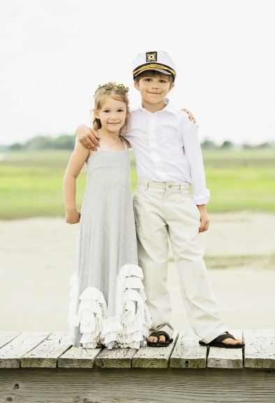 In a flowy maxi dress and floral wreath, flower girl Abby exuded hippie-chic. As an ode to the island (accessible only by boat), ring bearer Dominick upgraded his khakis and leather flip-flops with a captain’s hat.