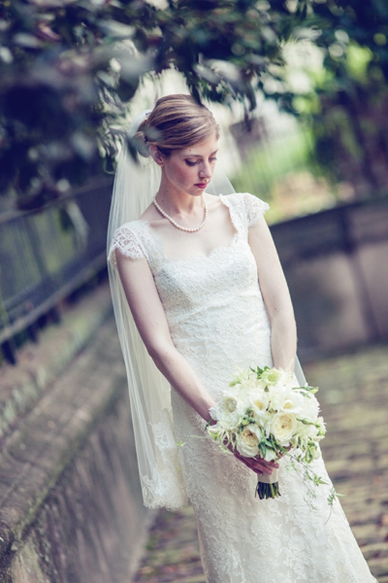 MONOCHROME: Kate’s bouquet of creamy white garden roses paired perfectly with her ivory lace gown.