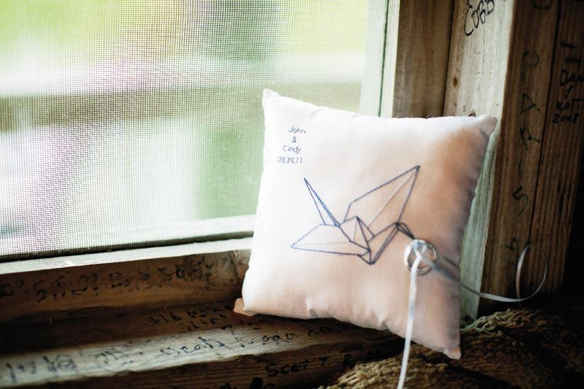 PILLOW TALK:  Cindy’s matron of  honor designed and stitched the ring bearer’s pillow; in lieu of a flower basket, the flower girl carried chains of paper cranes.