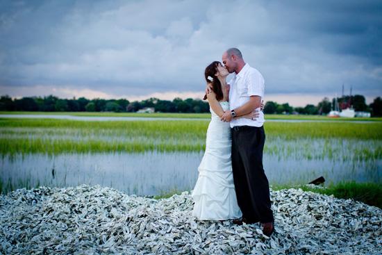 AW, SHUCKS: The couple, pictured here on a hill of oyster shells, kept their attire within budget: Cindy wore a gown from David’s Bridal, while John donned a Biton shirt and brown pants found at JCPenney.