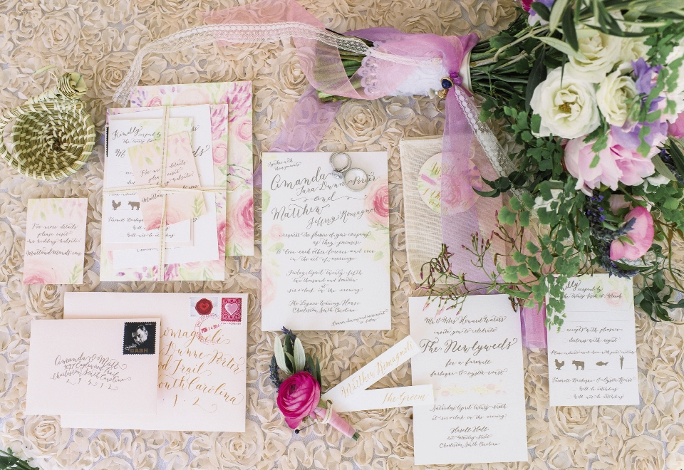 Original, hand-painted watercolor flowers were paired with gold script throughout the invitation suite and event signage.
