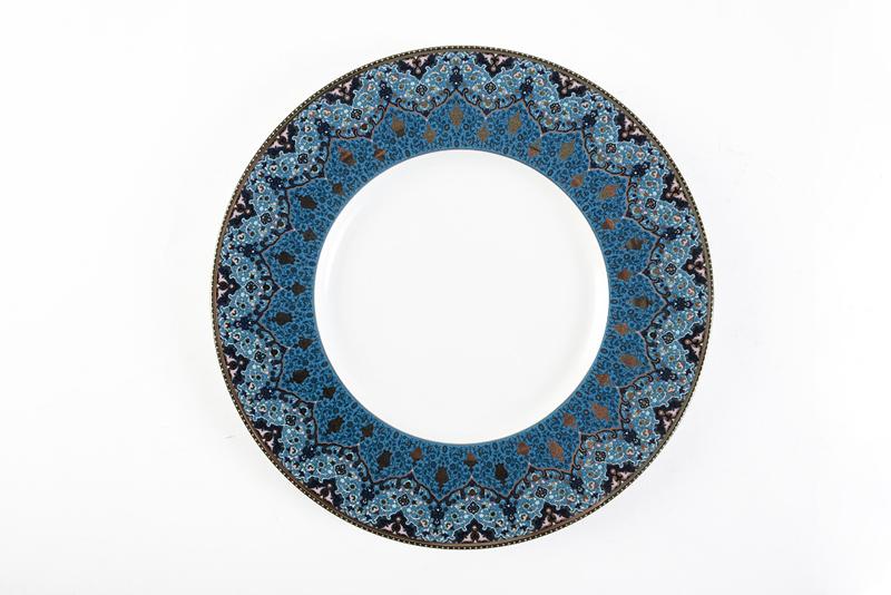 Dhara Peacock Dessert Plate. Embellished with platinum details, this pattern pulls inspiration from Persia and India. Jeffrey Bannon, $90 (9.5-inch plate)
