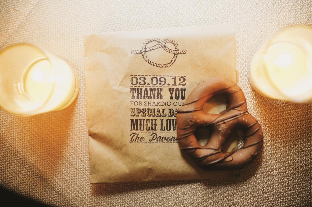 STAMP IT OUT: The wedding’s tie-the-knot motif appeared on pretzel favor bags with custom, inked on text thanks to Simon’s Stamps.