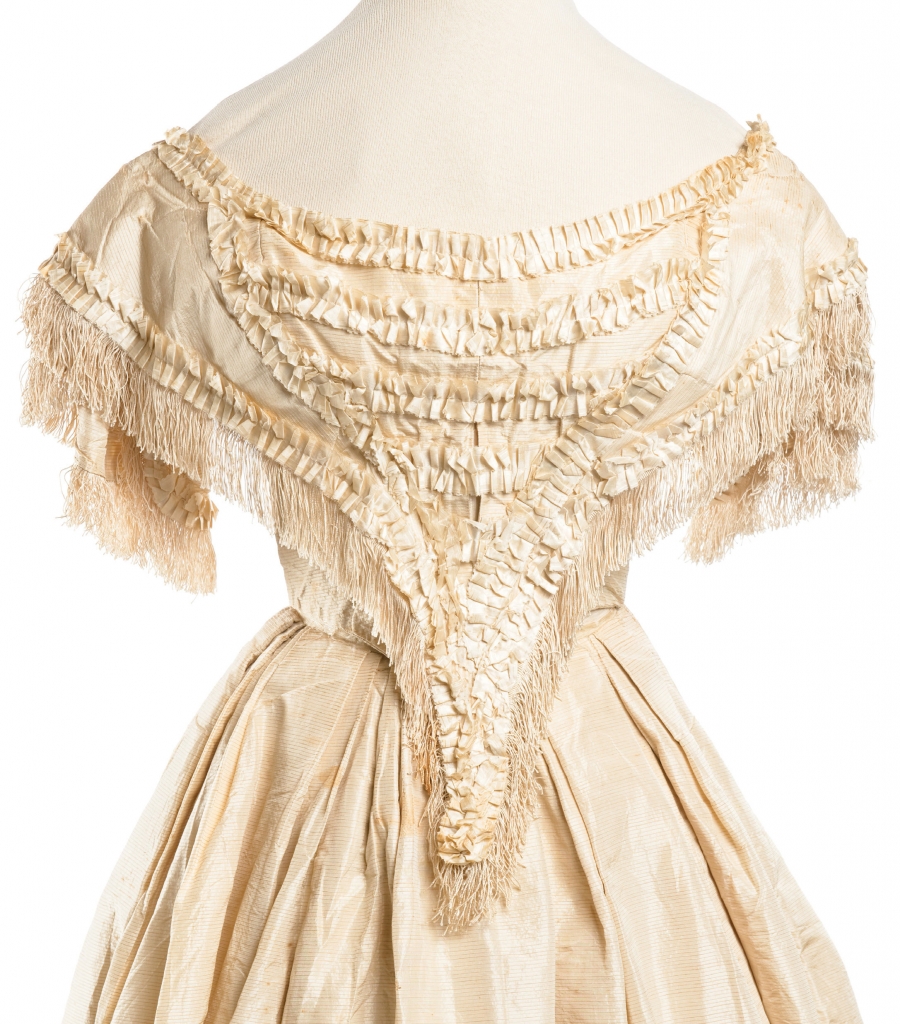 Louisa Jane Dearing, 1859: Paired with a billowing ball gown skirt, this silk taffeta top—complete with a scooped neckline, fringe, box pleating, and a laced-up corset—delivered the waist-cinching silhouette that was oh-so in vogue when bride Louisa Jane Dearing wed Charleston native Henry Edmondston on December 28, 1859, in Augusta, Georgia.