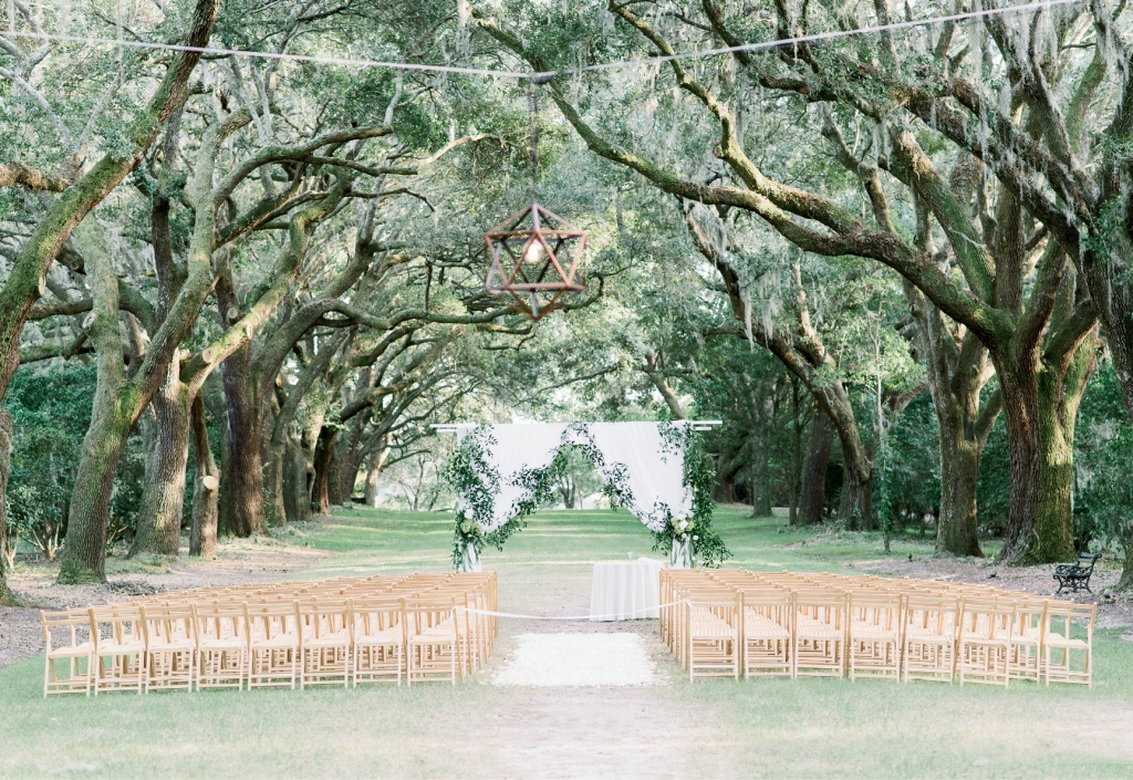 Shade from towering oak trees kept guests  cool during the alfresco ceremony.  &lt;i&gt;Image Aaron &amp; Jillian Photography&lt;/i&gt;