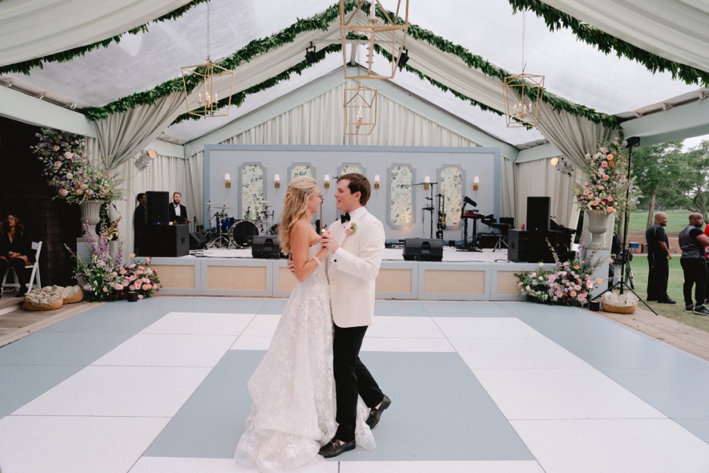 Clara and Grey enjoyed their first dance on a custom-wrapped floor alongside the marsh.