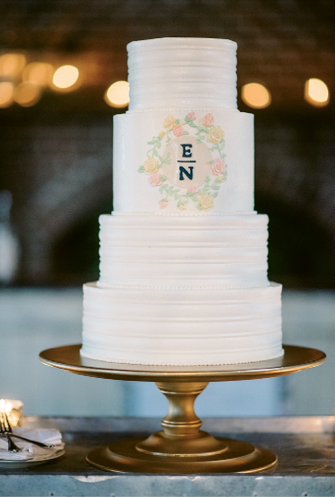 The cake by Ashley Bakery sported a monogram that mimicked that on the invitations. (Photograph by Sean Money + Elizabeth Fay)