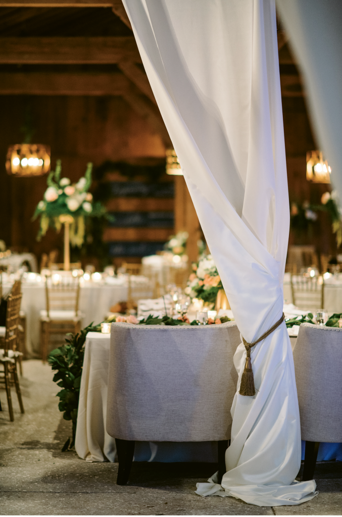 “Elizabeth wanted something beautiful and elegant but recognized that the reception was in a barn setting,” says A Charleston Bride planner Lindsey Shanks. “I love when a client understands not to ‘fight the grain’ of a space but opts to softly illuminate its features.” (Photograph by Sean Money + Elizabeth Fay)