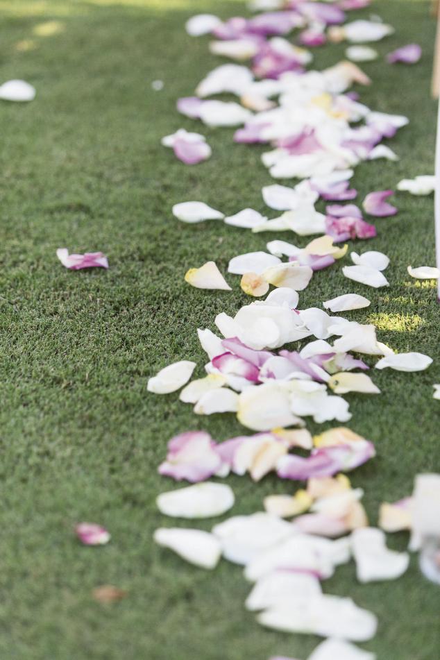 FLOWER POWER: The greens at Daniel Island Club are so pristine, a simple cascade of white and pale purple rose petals was more than enough to dress the aisle.