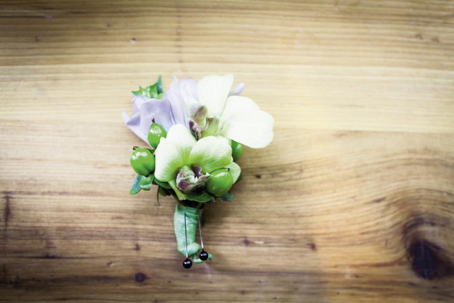 BADGE OF HONOR: Groomsmen  sported boutonnieres of orchids and green hypericum berries by OK Florist.