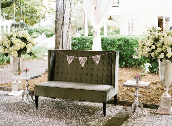 REST STOP: Melissa added whimsy (and color) to a pewter settee with pennants in the day’s signature violet damask print. Oversized silver vases were resplendent with masses of off-white blooms.